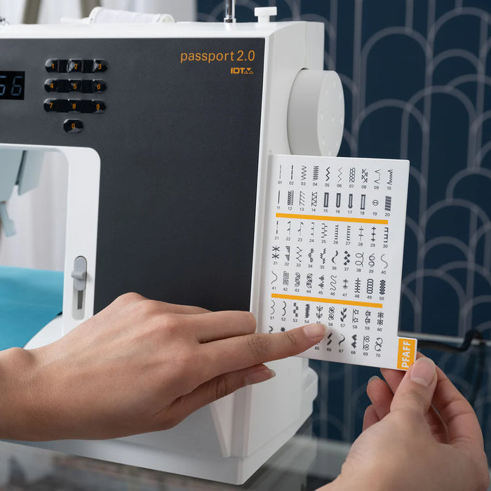 Person holding a card with symbols in front of a machine labeled 'passport 2.0'.