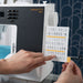 Person holding a card with symbols in front of a machine labeled 'passport 2.0'.