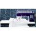 Sewing machine with a blue patterned wall in the background