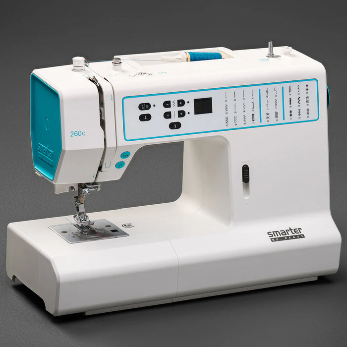 White sewing machine with blue accents on a dark background