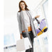 Woman holding a colorful bag and shopping bags with a blurred indoor background
