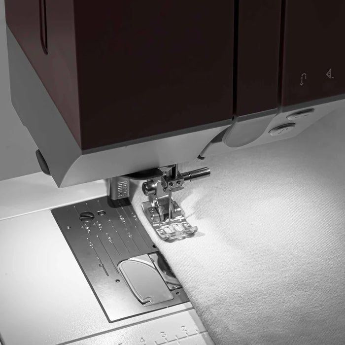 Close-up of a sewing machine with a focus on the needle and presser foot.