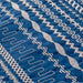 Close-up of blue fabric with white embroidery patterns