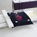 Embroidery machine stitching a design on a piece of fabric.