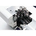 Close-up of a sewing machine's internal mechanism on a white background