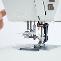 Close-up of a sewing machine with a white background