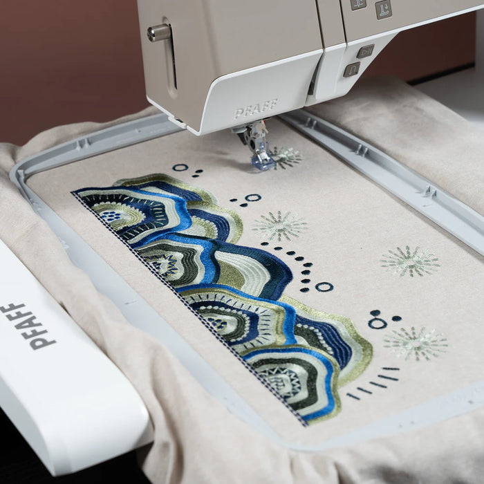 Embroidery machine with a colorful design on fabric