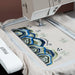 Embroidery machine with a colorful design on fabric