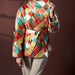 Multicolored quilted jacket worn by a person on a dark background