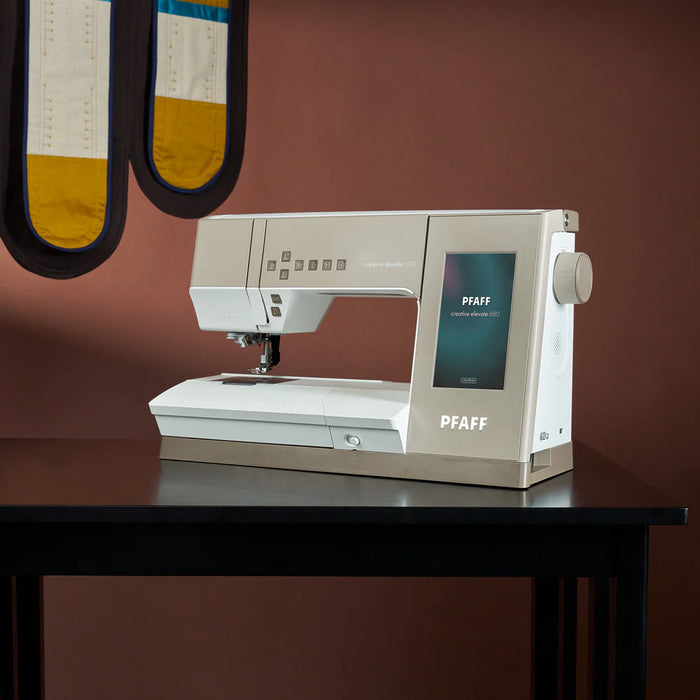 PFAFF sewing machine on a table with a brown background
