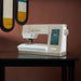 PFAFF sewing machine on a table with a brown background