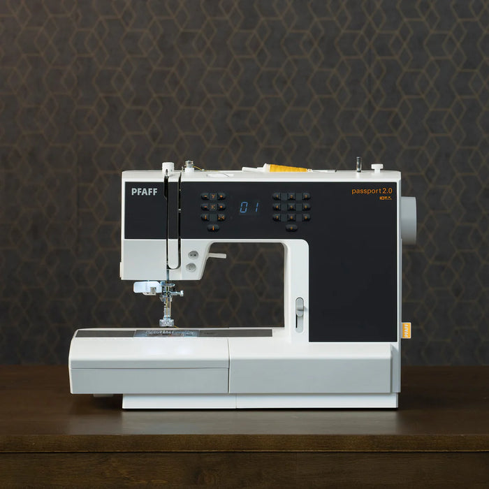 Sewing machine with 'PFAFF' branding on a dark background