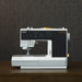 Sewing machine with 'PFAFF' branding on a dark background