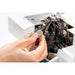 Hand adjusting a machine part on a white background