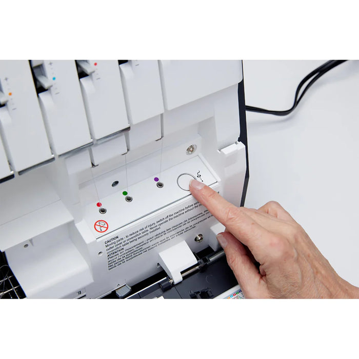 Hand pressing a button on a white electronic device with control panel