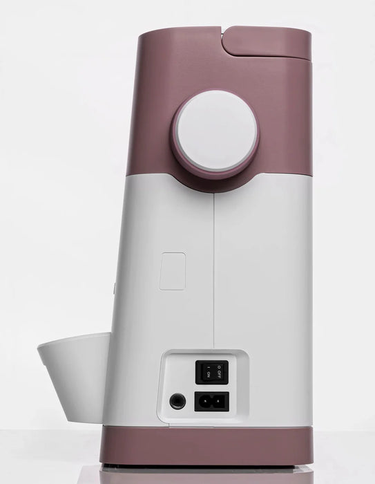 White and pink electronic device with power switch on a white background
