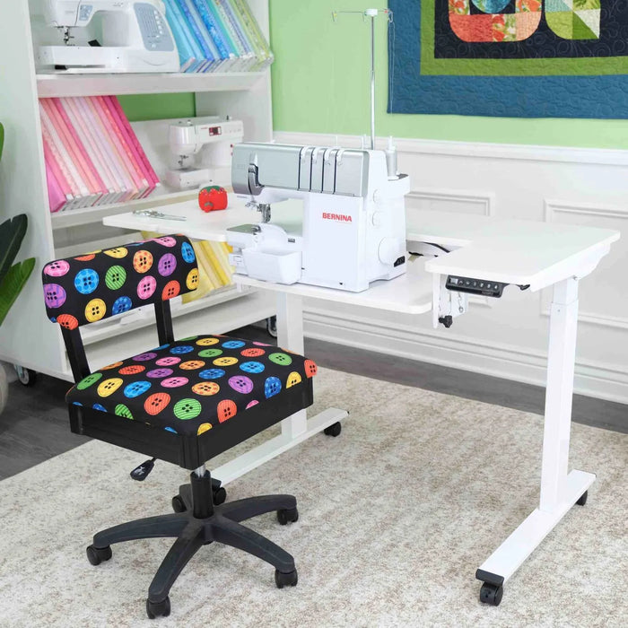 Arrow Eleanor 691 Sewing Table shown with Bernina serger and colorful Arrow sewing chair in studio setting.