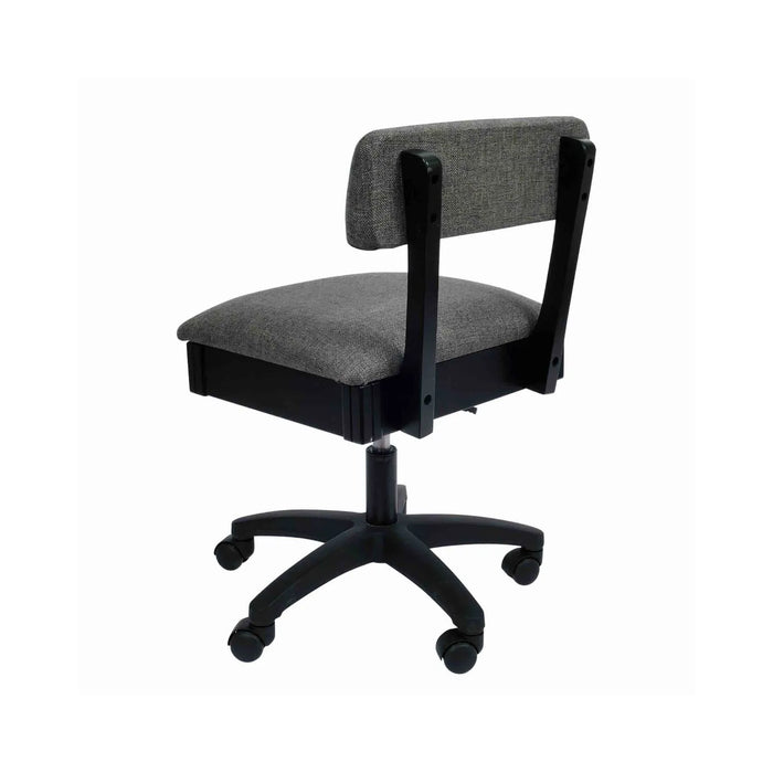 Arrow Lady Gray Hydraulic Sewing Chair – rear angle view showing textured gray fabric upholstery, supportive backrest, and smooth-rolling caster wheels.