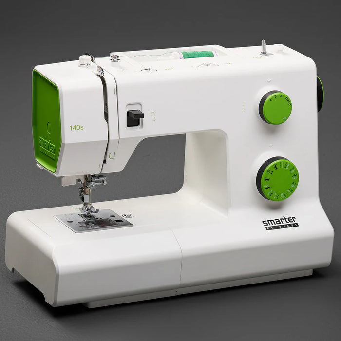 White sewing machine with green accents on a dark background