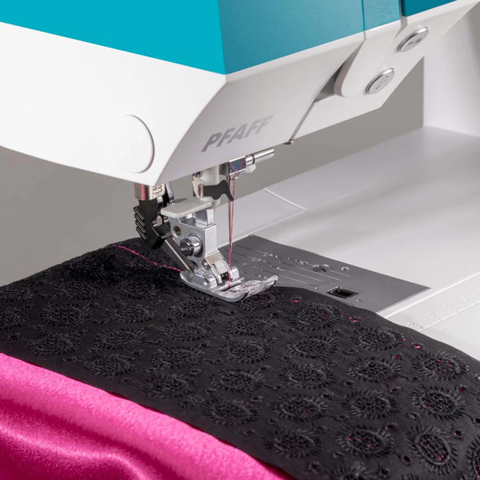 PFAFF sewing machine stitching black fabric on a white background