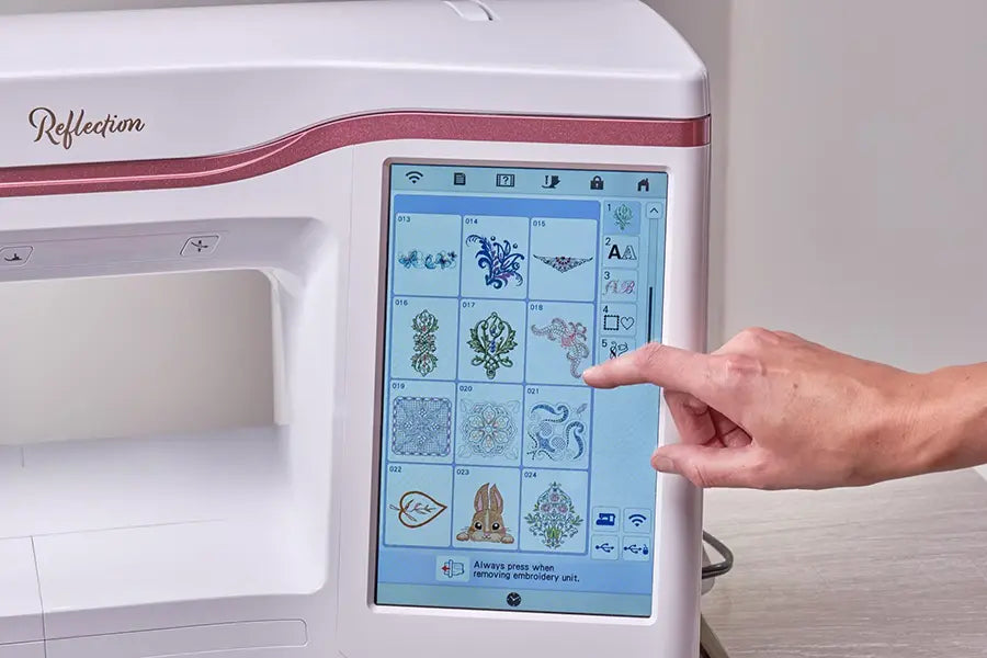 Baby Lock Reflection BLRT touchscreen display showing built-in embroidery designs, offering easy on-screen selection and editing.