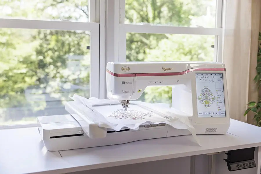 Baby Lock BLRT Reflection embroidery-only machine stitching a floral design near a window, highlighting its large workspace and intuitive features.