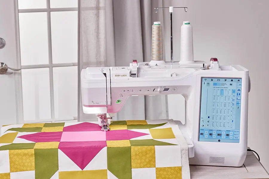 Baby Lock Anthem BLAN quilting machine stitching a colorful quilt block with dual thread stands attached