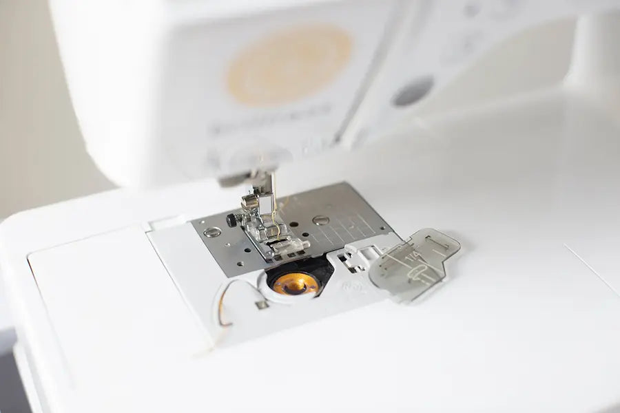 Close-up of Baby Lock Brilliant sewing machine quick-set drop-in bobbin system