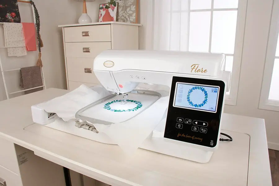 Baby Lock Flare BLMFL embroidery machine on sewing table creating a circular floral embroidery design.