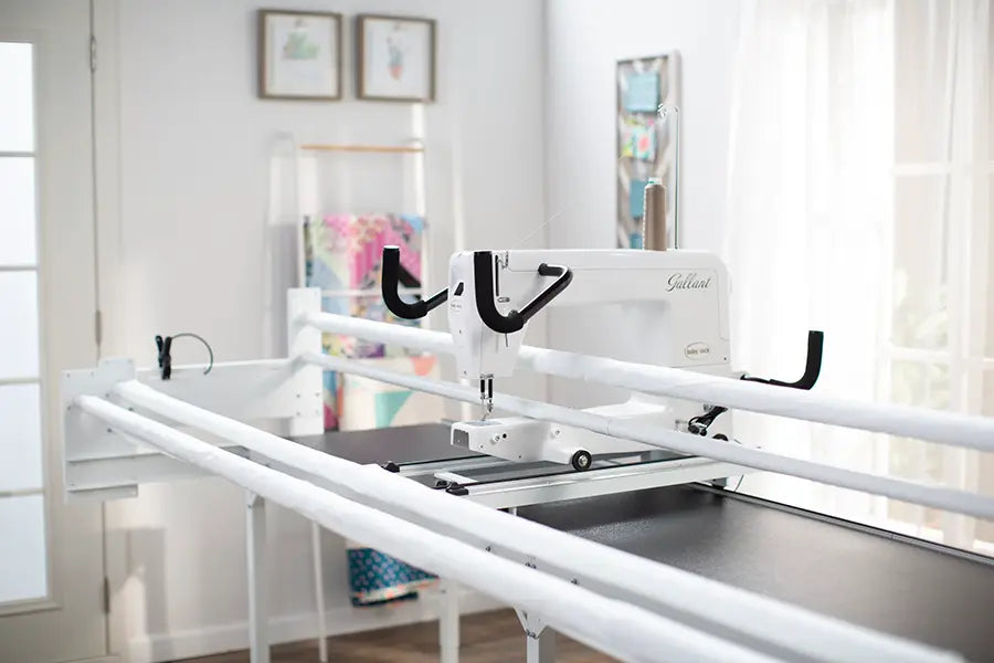 Baby Lock Gallant XL longarm machine positioned on Villa 2 quilting frame with extended workspace in sewing room