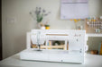Baby Lock Jazz II BLMJZ-2D sewing and quilting machine displayed in a modern home sewing studio with extended 12-inch workspace.