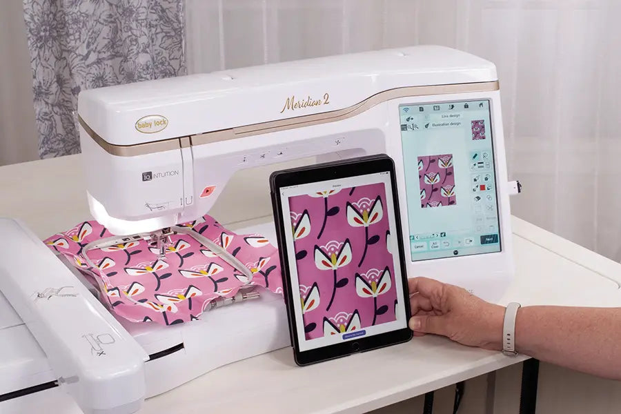 Baby Lock Meridian 2 embroidery machine using IQ Intuition Positioning with a tablet to wirelessly transfer a floral design for perfect hoop placement.