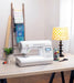 Baby Lock Presto II sewing machine displayed in a home sewing studio on a cutting table with quilting supplies
