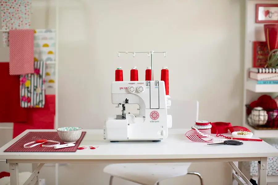 Baby Lock Vibrant BL460B serger displayed on a sewing table in a craft room—ideal overlock machine for garment makers and home sewing projects.