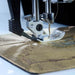 Sewing machine needle on fabric with a blurred background