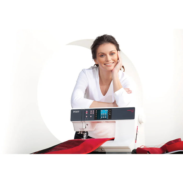 Woman sitting at a sewing machine with a white background