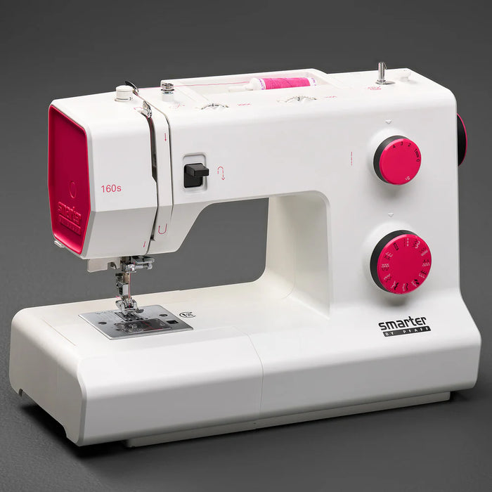 White sewing machine with pink accents on a gray background