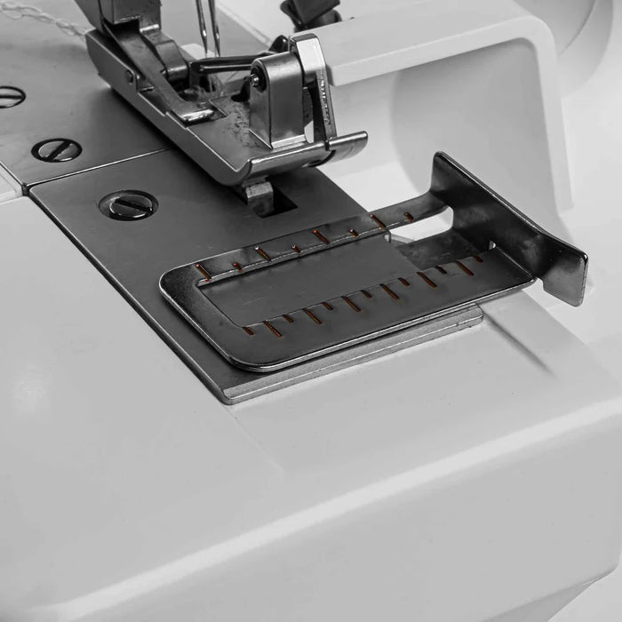 Close-up of a sewing machine needle plate with a white background