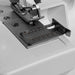 Close-up of a sewing machine needle plate with a white background