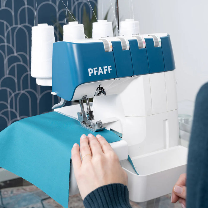 PFAFF sewing machine with a person operating it, set against a neutral background.
