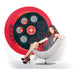 Woman sitting in a modern chair with a large circular red object in the background