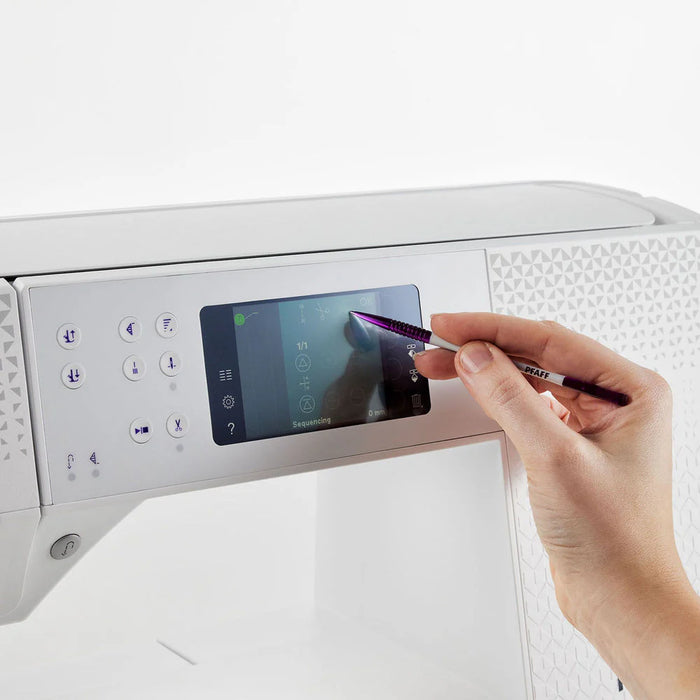 Person using a stylus to interact with a digital display on a white appliance.