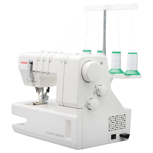 Angled side view of the Janome CoverPro 2000CPX coverstitch machine displaying thread stand, tension dials, and control knobs for advanced garment finishing.