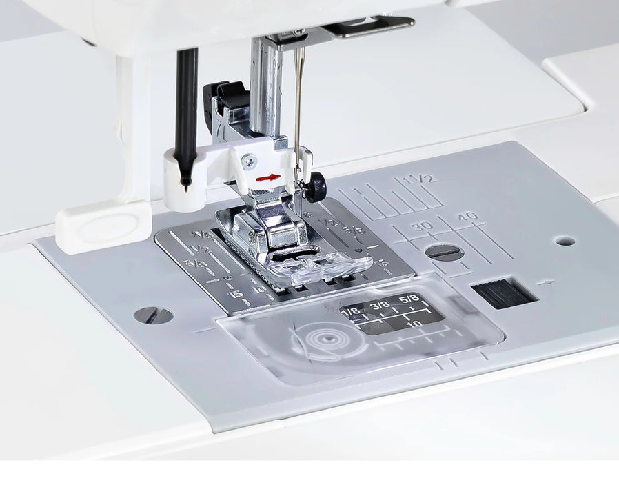 Close-up of the Janome 2030DC-G needle plate, presser foot, and measurement guides for precision stitching