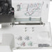 Janome 8002D Serger interior threading diagram and lower looper area displayed with color-coded guides for easy setup.