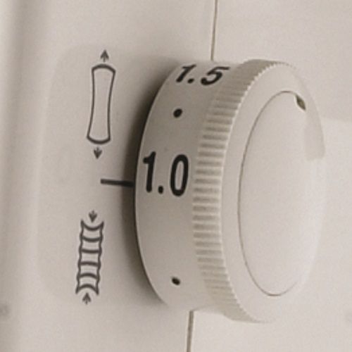 Janome 8002D Serger differential feed adjustment dial showing stitch control options for perfect fabric handling.