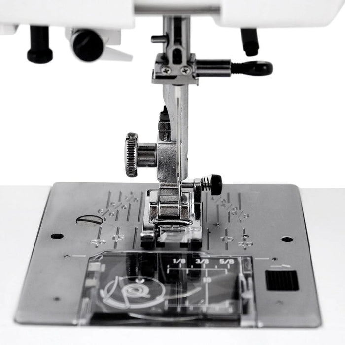 Close-up of the Janome HD-3000 needle area, presser foot, and stainless-steel needle plate for precision sewing.