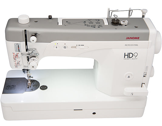 Top and front view of Janome HD9V2 Professional Sewing Machine showing thread path, controls, and extra-wide sewing surface.
