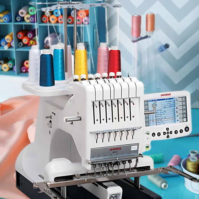 Janome MB-7 multi-needle embroidery machine in sewing studio with thread spools, professional seven-needle embroidery setup for high-detail stitching and small business production.