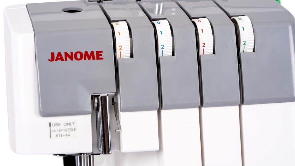 Close-up of Janome MyLock 454D serger tension dials with color-coded threading system for easy stitch adjustments.